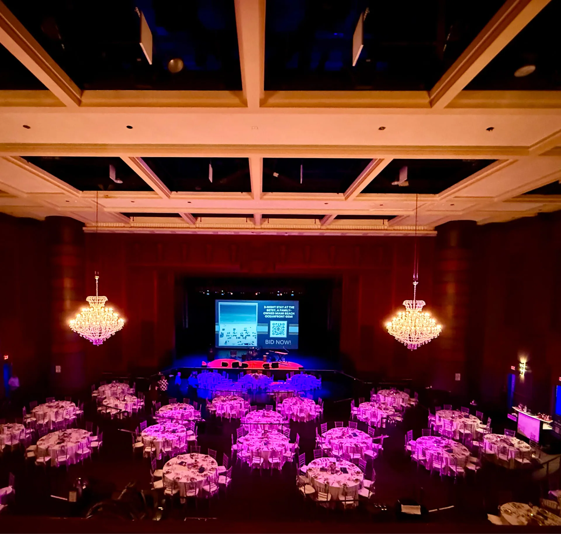 Spacious indoor venue at NOVA 535 with wooden ground and white chairs