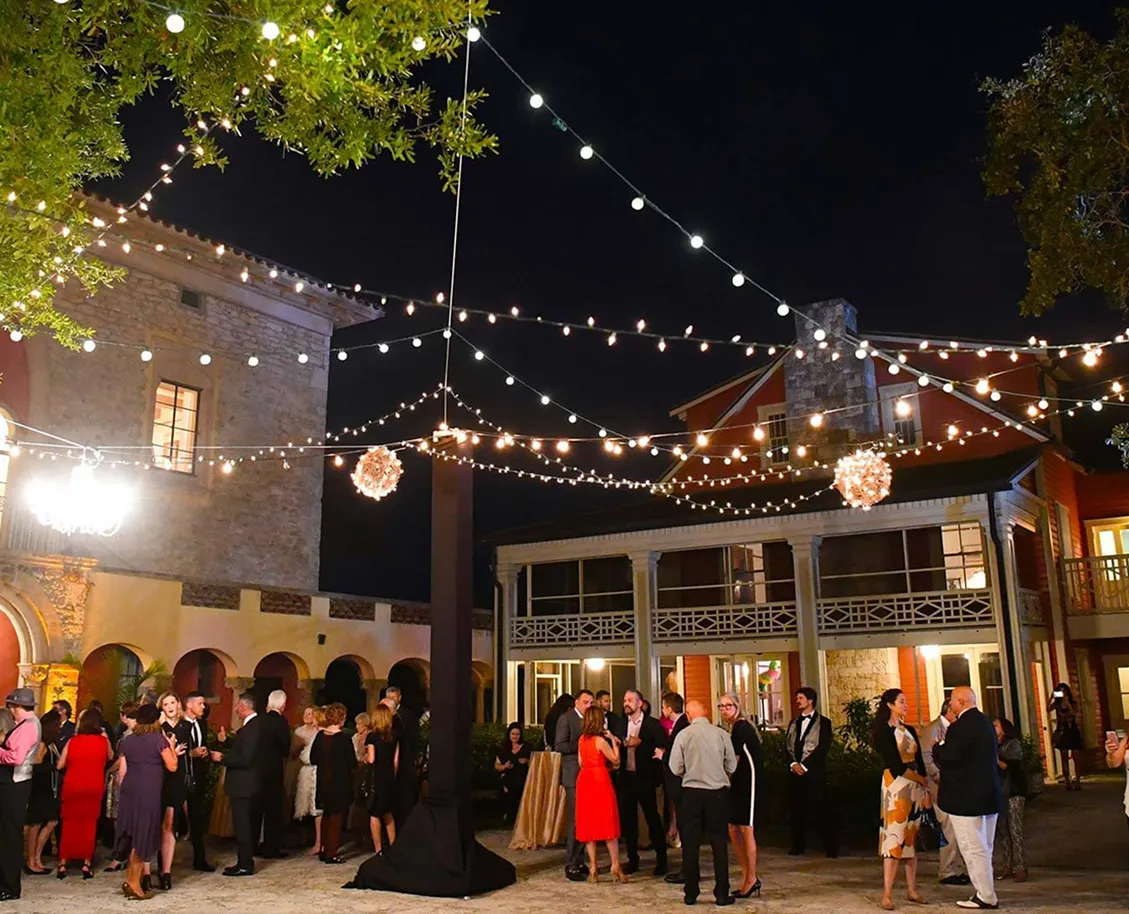Exterior view of Deering Estate with palm trees, a golf course, and a clubhouse