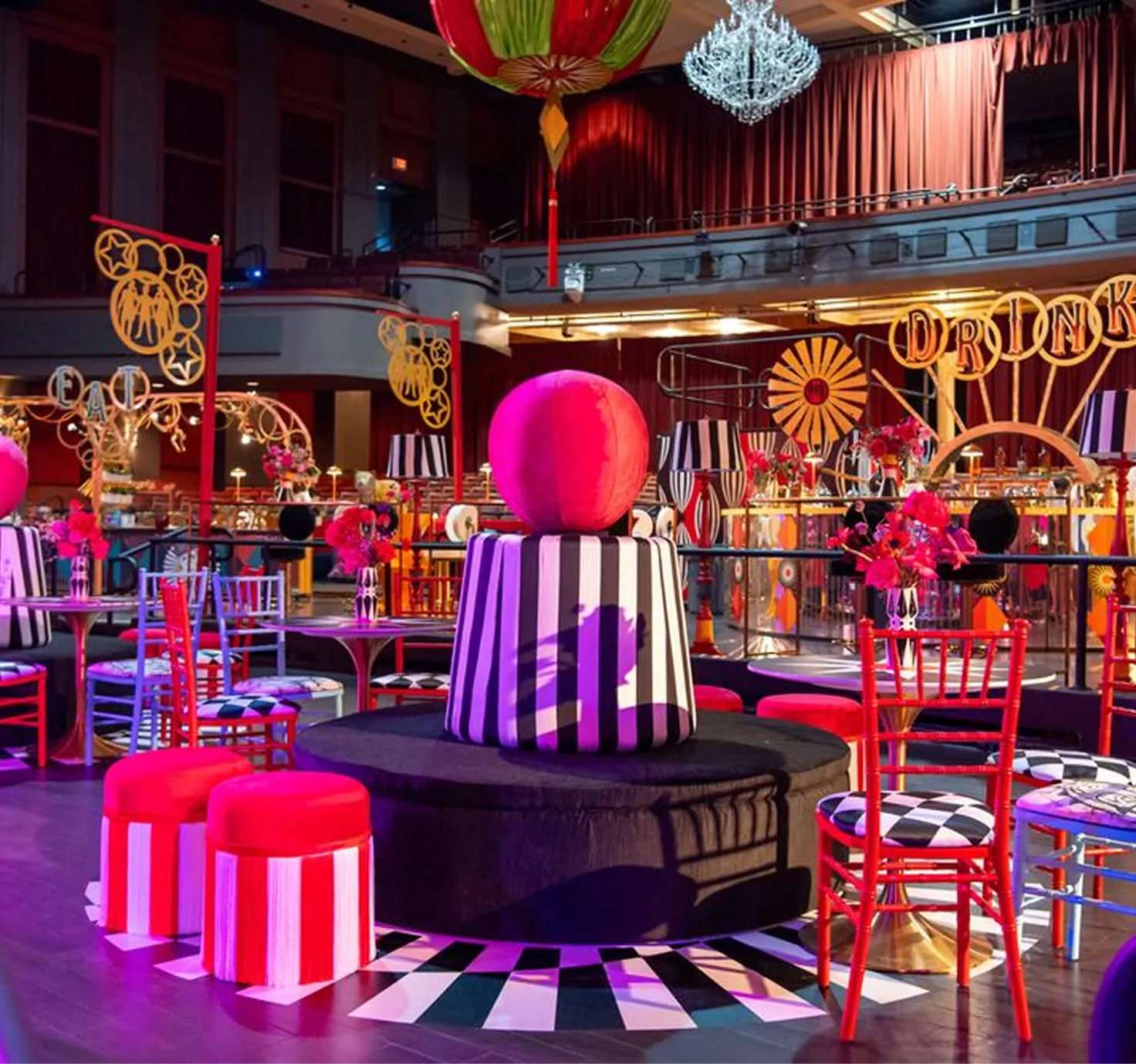 Indoor wedding ceremony at Nova 535 with brick wall backdrop, hanging lights, floral arch, and elegant bridal party setting