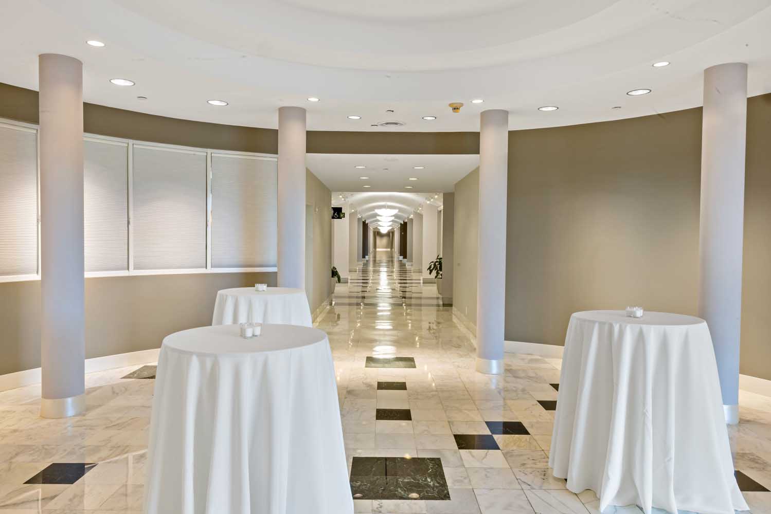 Pre-function area at Palmetto Bay Village Center with high-top cocktail tables and polished marble floors