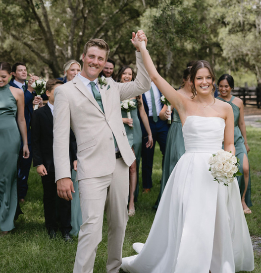 Rustic indoor wedding setup at Trellis 925 with  draped ceiling, string lights, and elegant white table decor