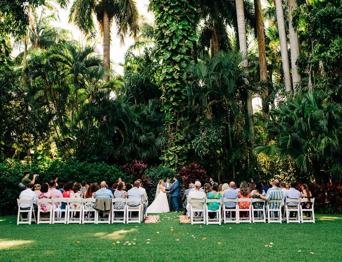 Outdoor wedding ceremony at Sunken Garden with guests seated on chairs facing the couple during the vows