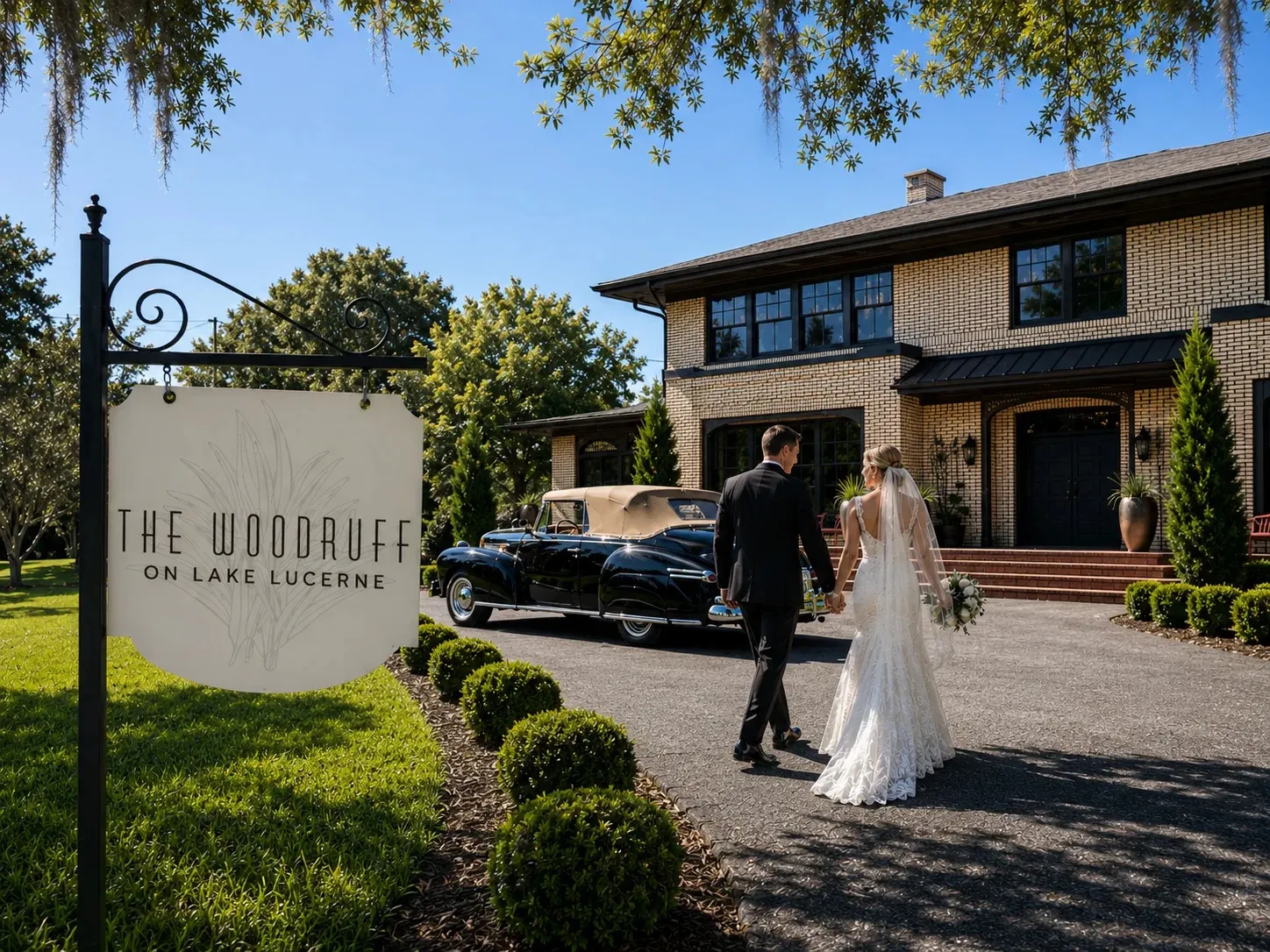 Bride and groom walking toward a classic car on the lawn in front of The Woodruff on Lake Lucerne