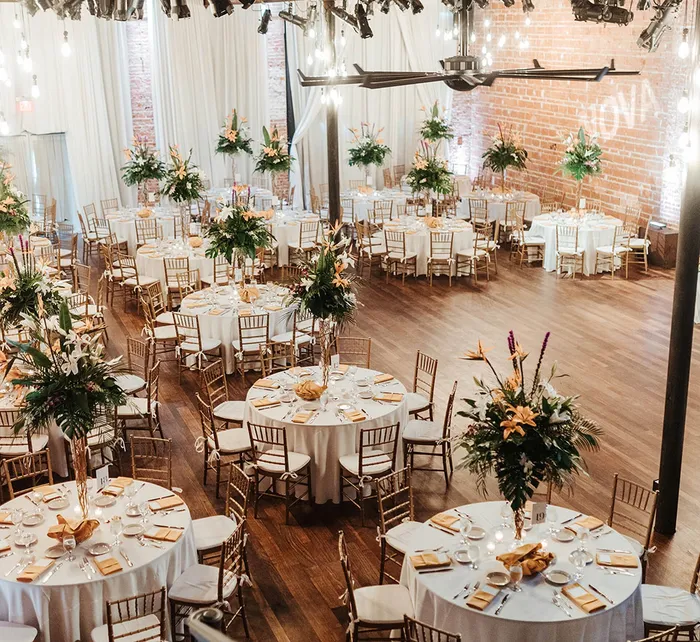Wedding ceremony at Nova 535 with the couple exchanging vows surrounded by bridesmaids, groomsmen, and lush tropical greenery