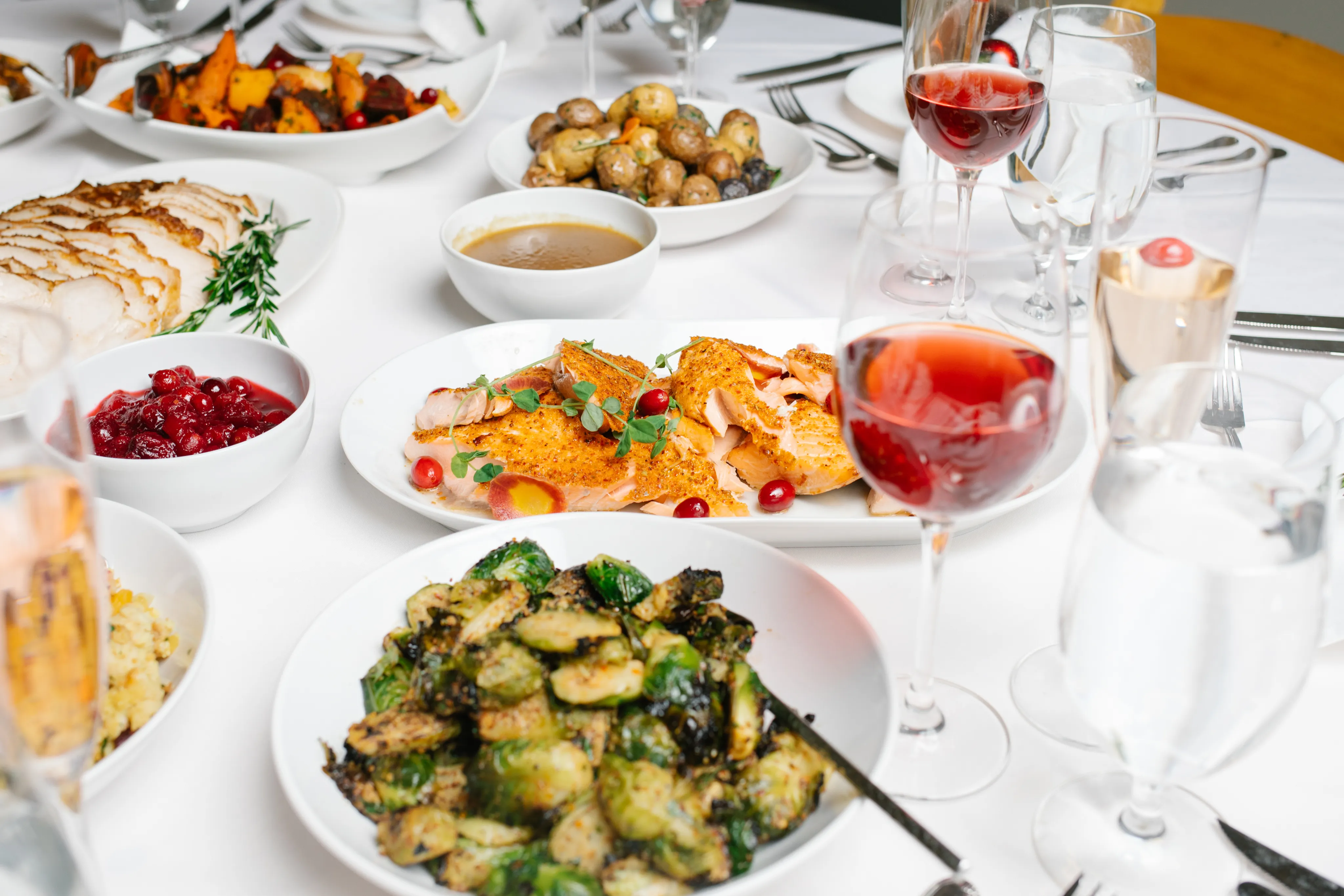 Plated salmon with gravy, roasted potatoes and Brussels sprouts